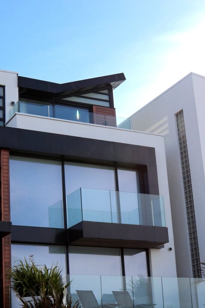 Contemporary luxury home with glass balconies in Poole, UK, showcasing modern architectural design.