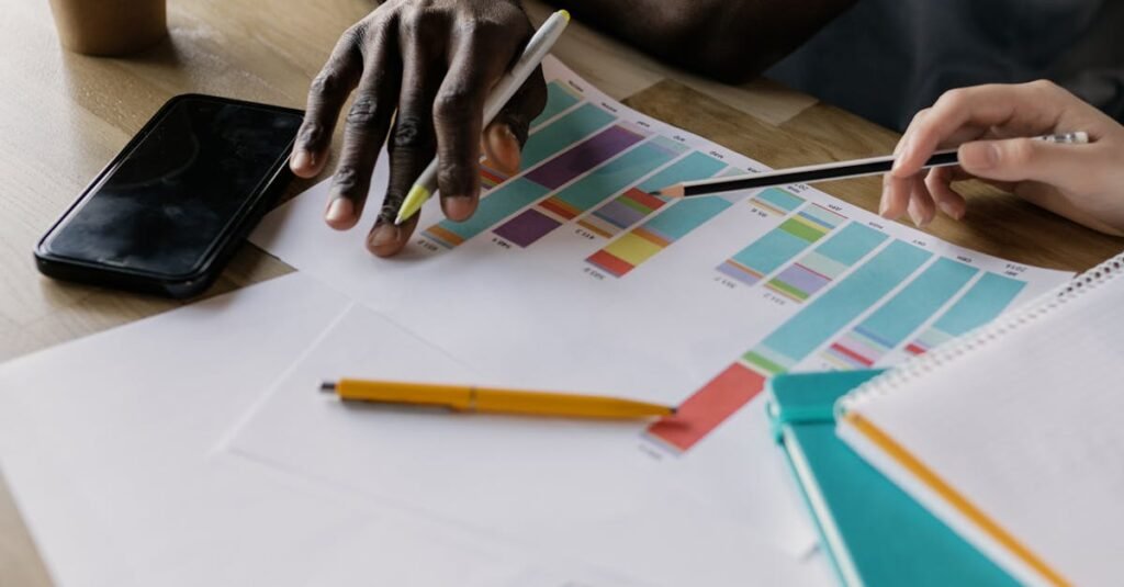 Two business professionals collaborating on a colorful project plan indoors.